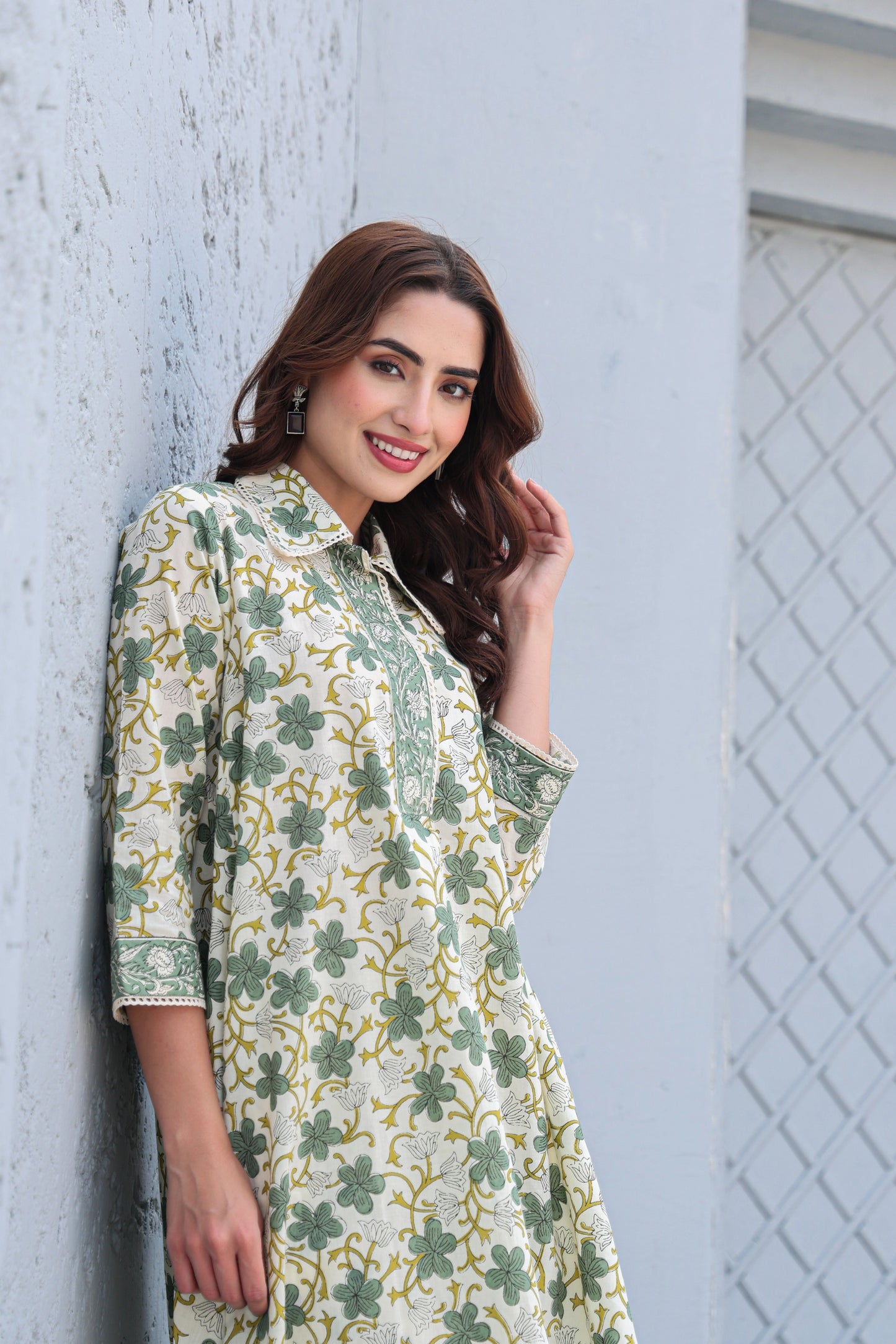 Model wearing white and green floral cotton A-line kurta pant set
